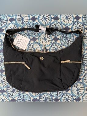 NWT lululemon Black slouchy sling bag 6L w/ gold metal hardware